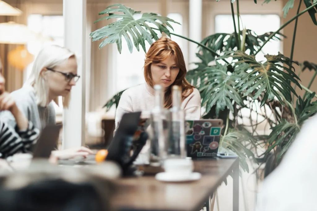 Colleagues working with laptops in a modern enterprise office