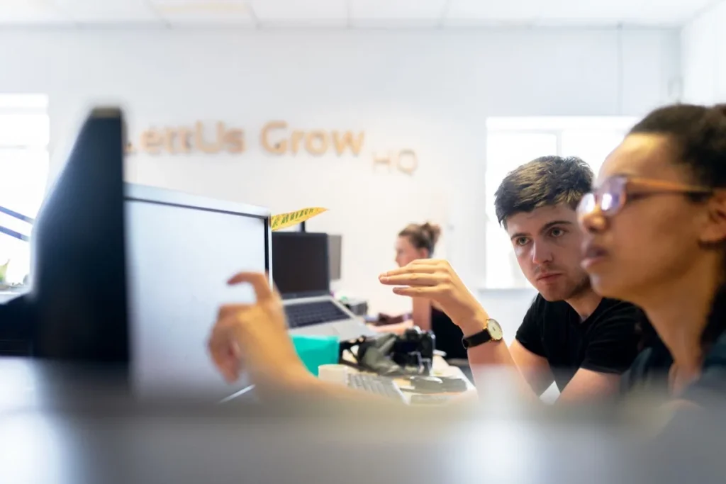 Engineers collaborating closely in a modern office environment