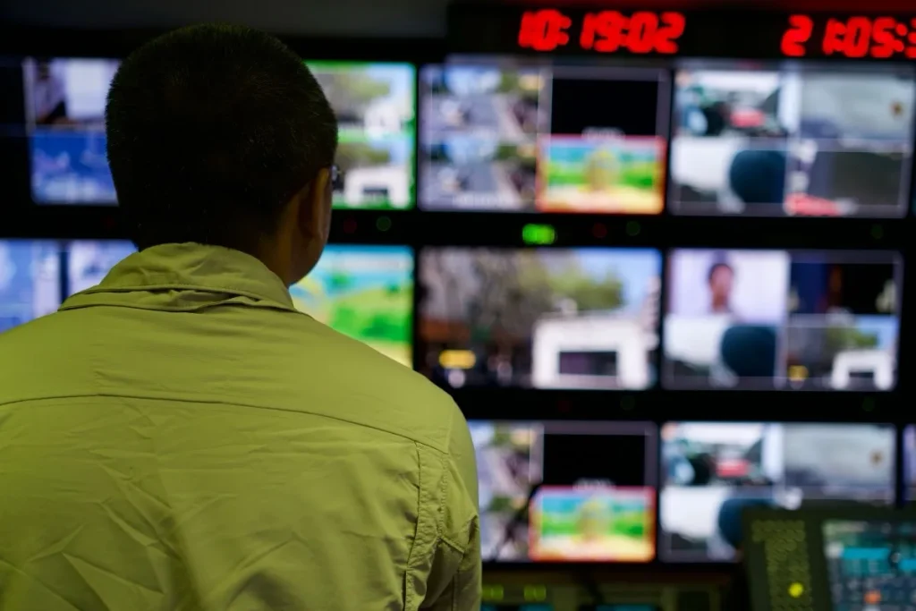 An engineer overseeing multiple monitoring dashboards