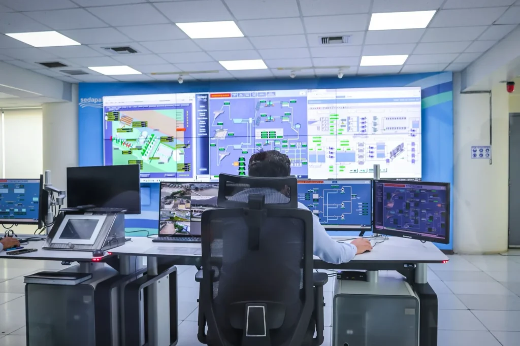 An operator monitoring production systems in a modern control room